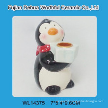 Ceramic candle holder with penguin design